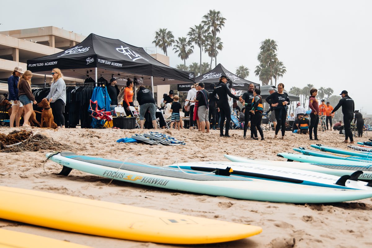 Surfboards and tents set up on the beach for an event