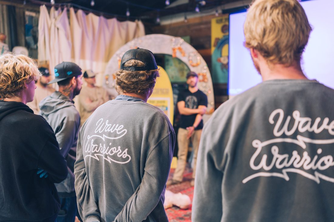Wave Warriors sweatshirts in the crowd at a Flow community event