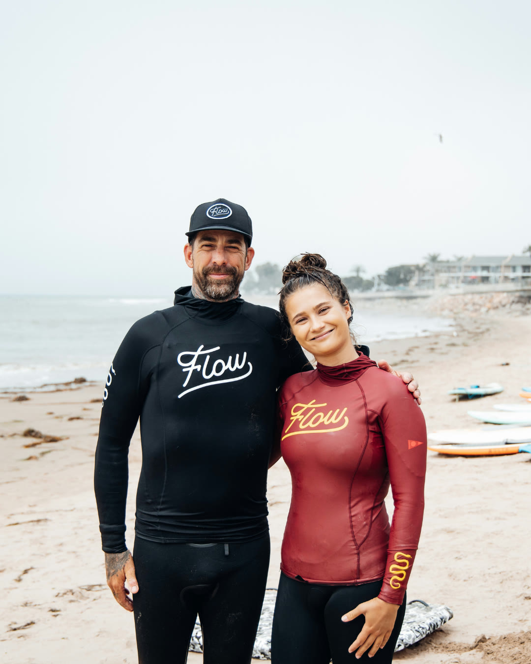 Pat Notaro III, founder of Flow Surf Academy, on the beach in a Flow rashguard